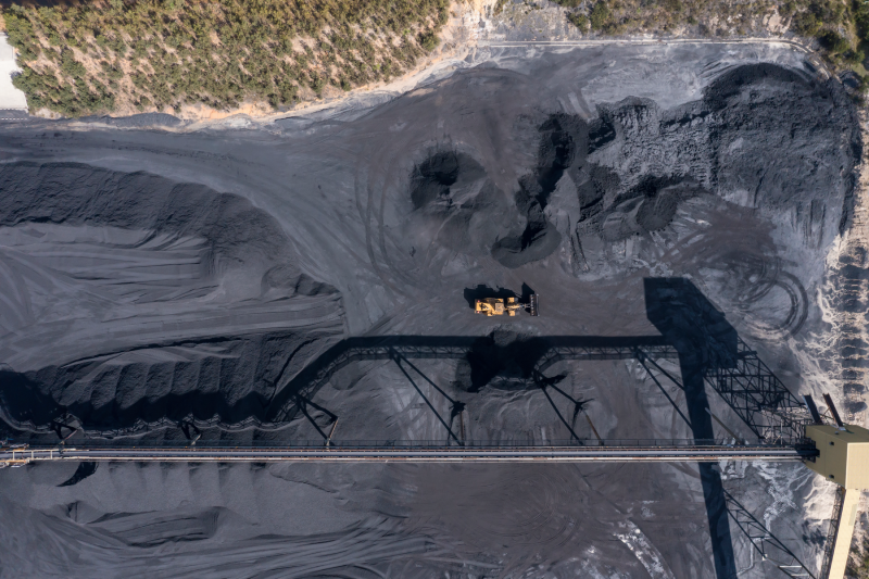 rone aerial photograph of industrial machinery processing and moving crushed coal in a Colliery in regional Australia.